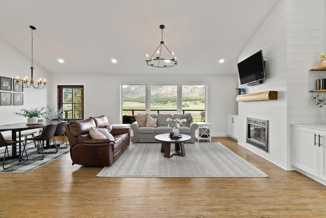 2419 Indian Ridge Rd, Chewelah, WA 99109 - living room featuring a chandelier, a fireplace, light wood finished floors, recessed lighting, and high vaulted ceiling