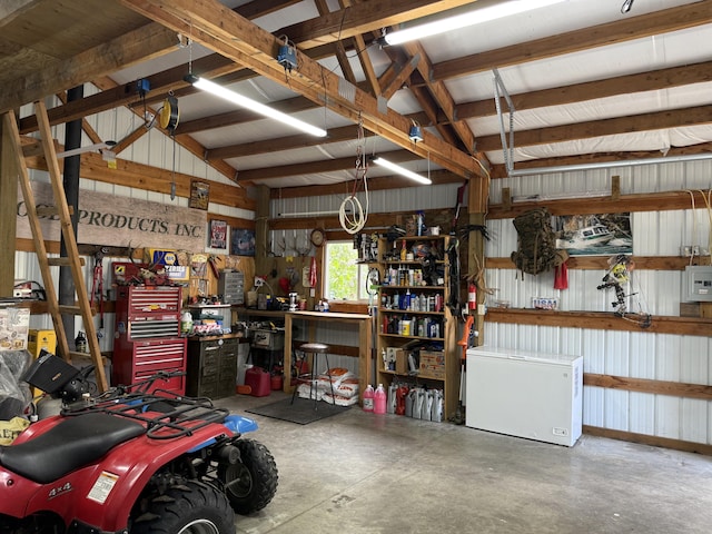 garage with a workshop area and fridge