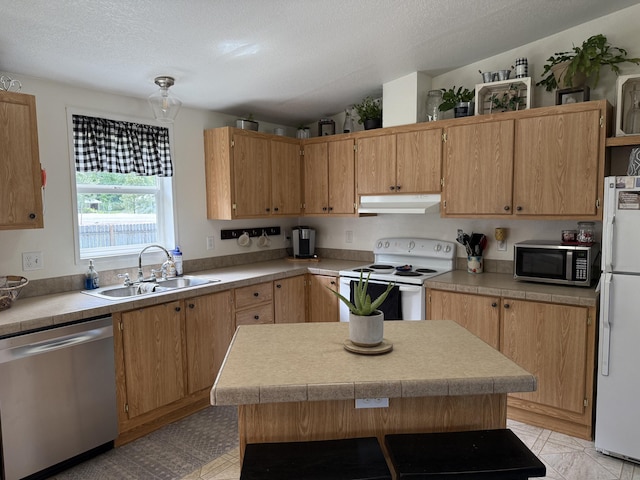 kitchen with appliances with stainless steel finishes, a sink, under cabinet range hood, light countertops, and a textured ceiling