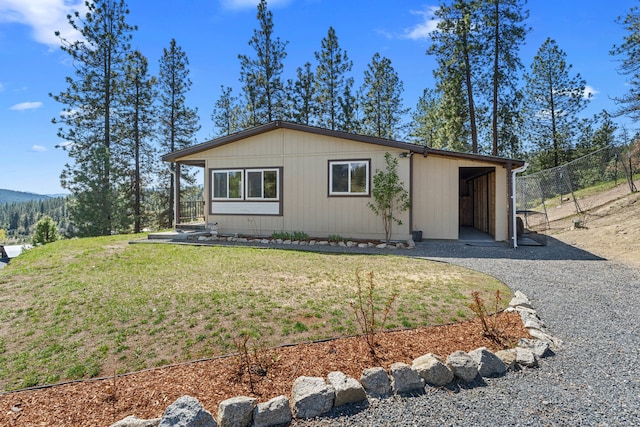 view of front of house with a front lawn and fence