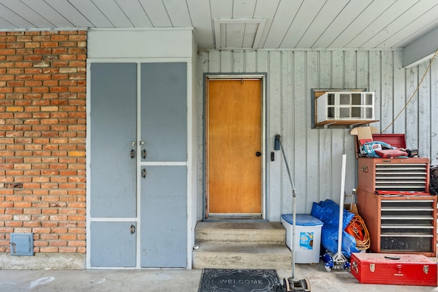 entrance to property with brick siding and board and batten siding