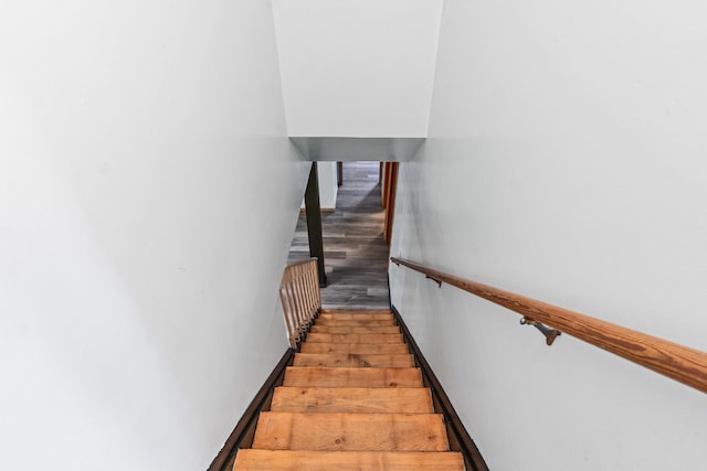stairs featuring wood finished floors