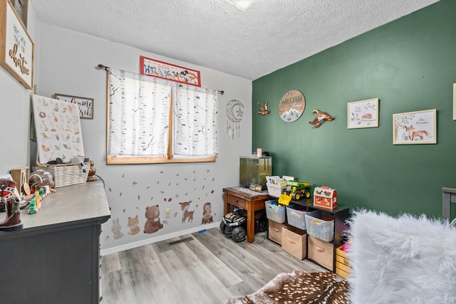 office area featuring a textured ceiling, wood finished floors, and baseboards