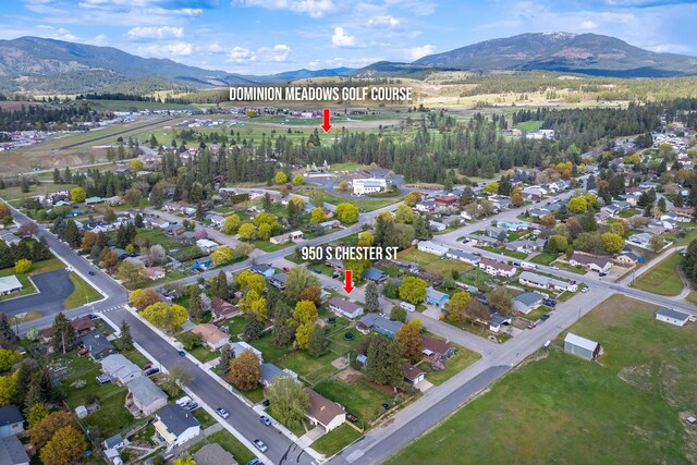 birds eye view of property with a mountain view
