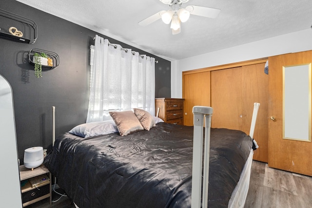 bedroom featuring a closet, ceiling fan, and wood finished floors