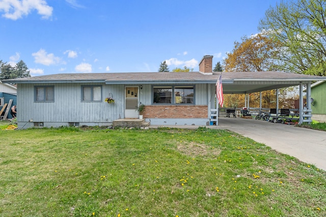 ranch-style home featuring a carport, concrete driveway, a chimney, a front lawn, and brick siding