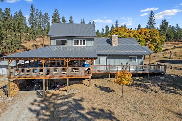 rear view of property featuring a deck