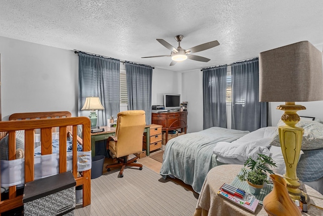 bedroom featuring a textured ceiling and ceiling fan
