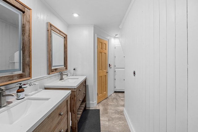 bathroom with vanity, crown molding, tile patterned floors, and wooden walls