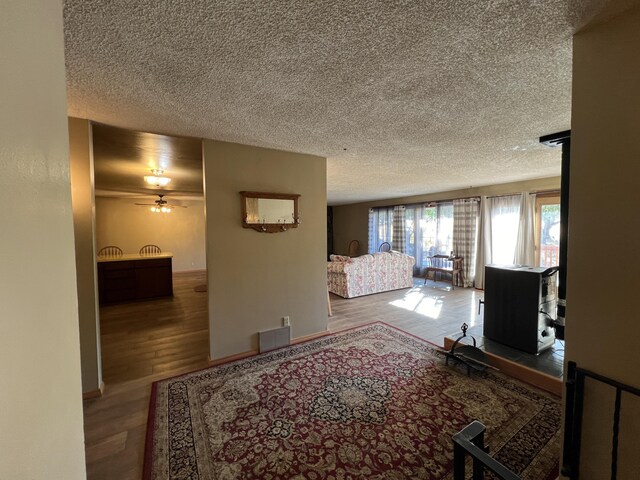 bedroom with hardwood / wood-style floors and a textured ceiling