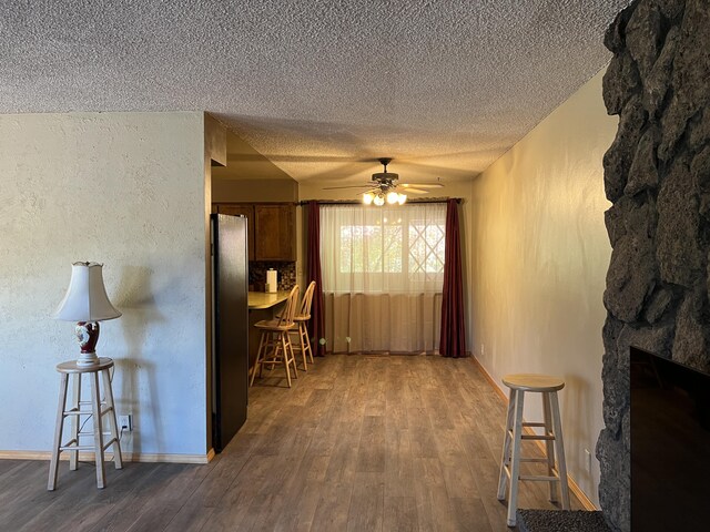 hall featuring hardwood / wood-style flooring and a textured ceiling