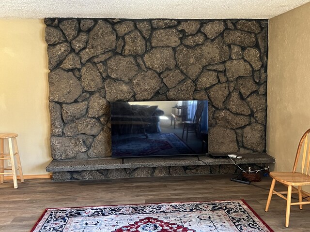 details featuring a fireplace, hardwood / wood-style flooring, and a textured ceiling