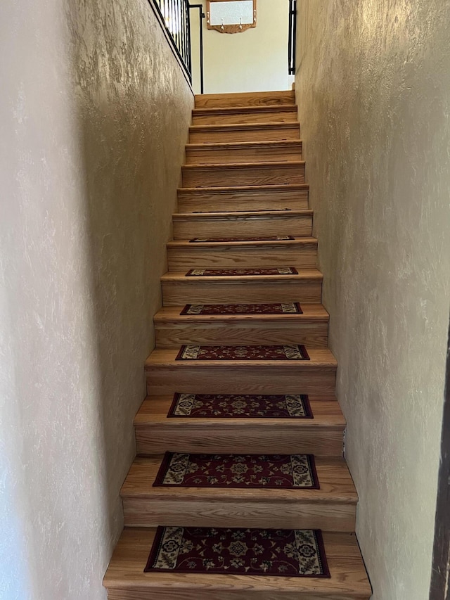 staircase with hardwood / wood-style flooring