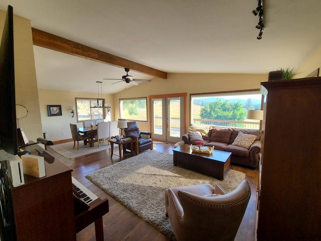 living room featuring hardwood / wood-style flooring, plenty of natural light, french doors, and vaulted ceiling with beams