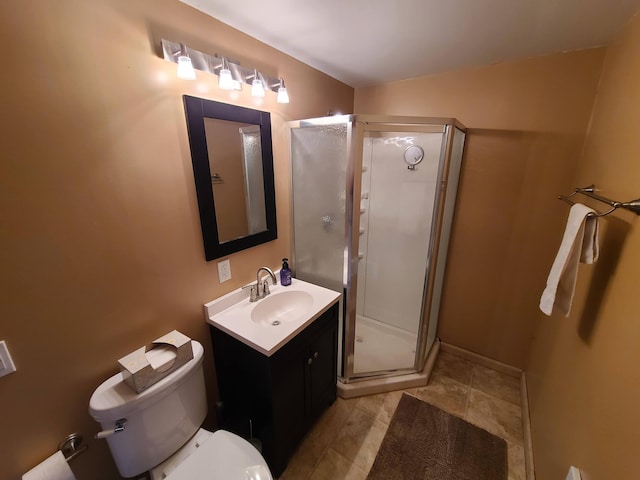 bathroom featuring toilet, an enclosed shower, and vanity