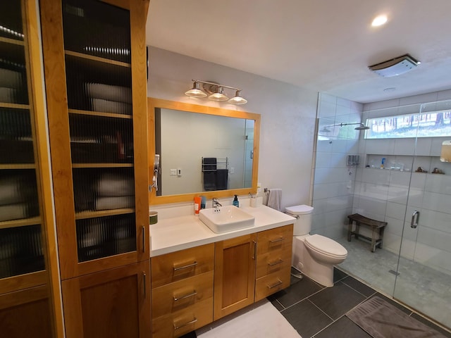 bathroom with toilet, an enclosed shower, tile patterned floors, and vanity