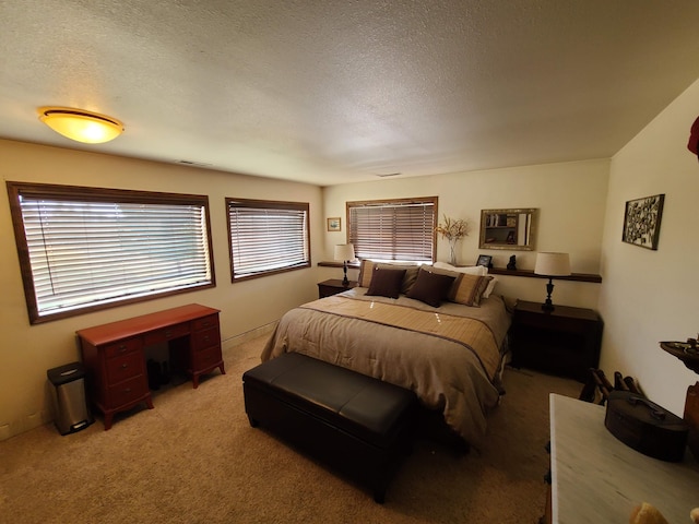 bedroom featuring carpet floors and a textured ceiling