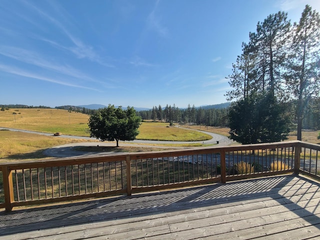 wooden deck with a rural view