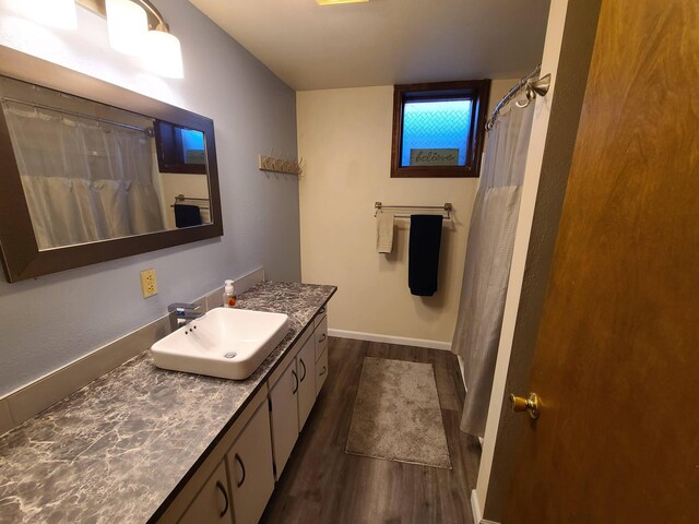 bathroom featuring hardwood / wood-style floors, curtained shower, and vanity