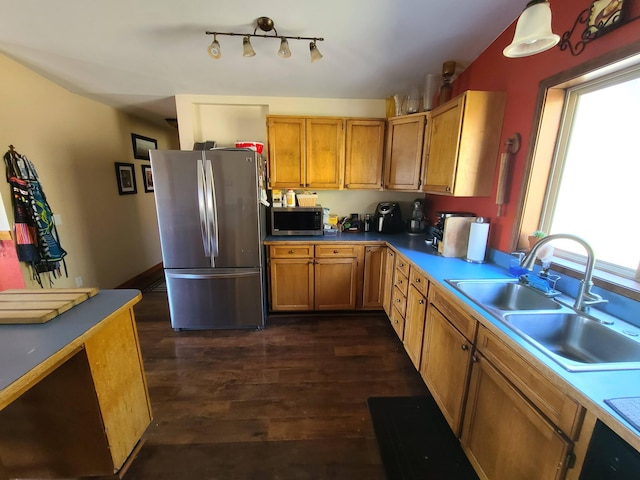 kitchen with sink, appliances with stainless steel finishes, and dark wood-type flooring