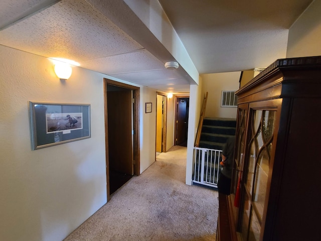 corridor with light colored carpet