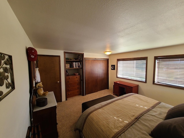 carpeted bedroom featuring a textured ceiling