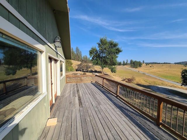 wooden terrace featuring a rural view