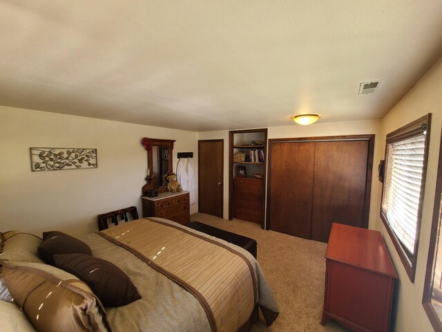 carpeted bedroom with a closet