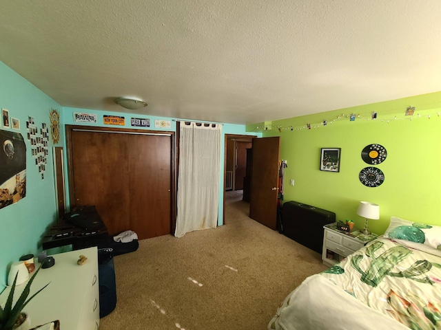 carpeted bedroom with a textured ceiling and a closet