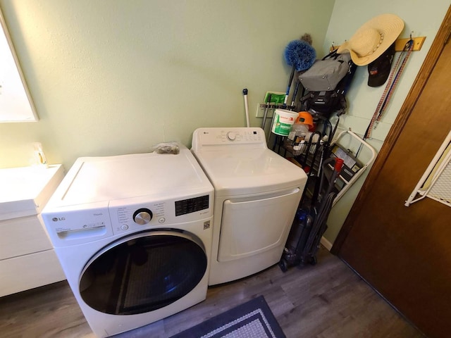 laundry room featuring dark hardwood / wood-style flooring and washing machine and clothes dryer