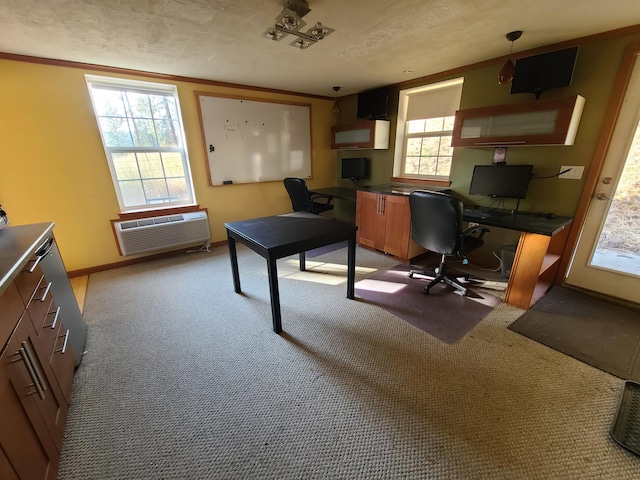 carpeted office with a textured ceiling and a wall mounted AC