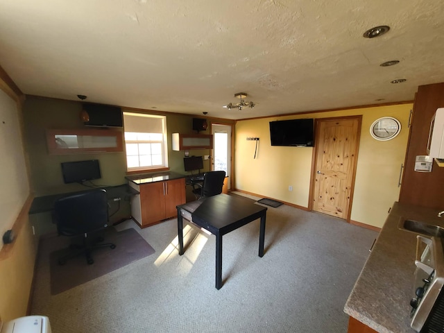 playroom featuring built in desk, crown molding, and light carpet