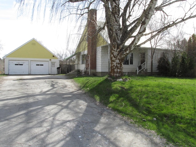 view of front of home with a garage and a front lawn