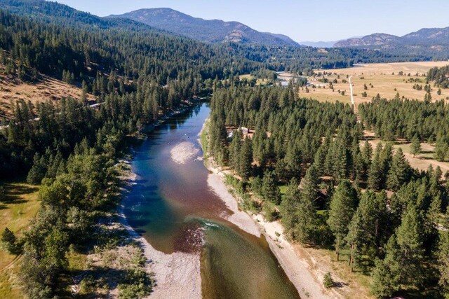 drone / aerial view featuring a water and mountain view