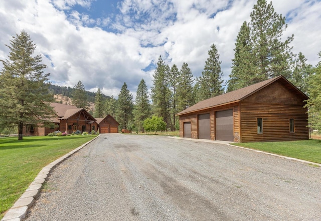 exterior space featuring a garage, a front yard, and an outdoor structure