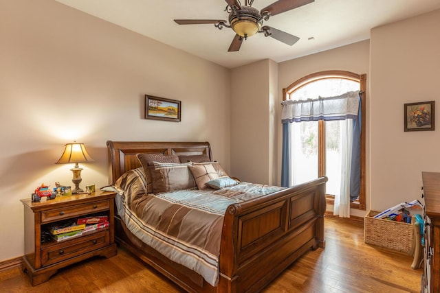 bedroom with ceiling fan and light hardwood / wood-style flooring