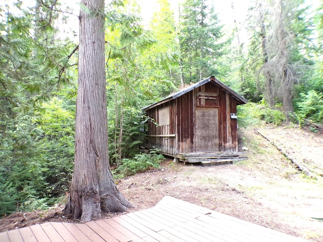 view of shed with a view of trees