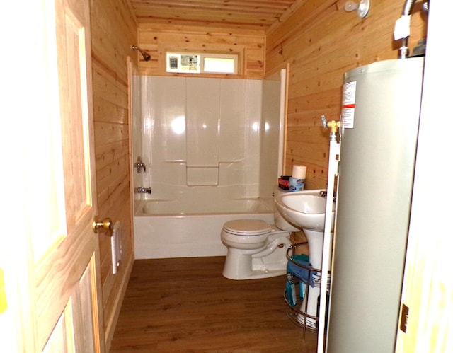 bathroom featuring wood-type flooring, toilet, gas water heater, and wooden walls