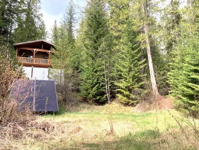3121 Fifteen Mile Creek Rd, Kettle Falls, WA 99141 - view of outbuilding with a view of trees and solar panels