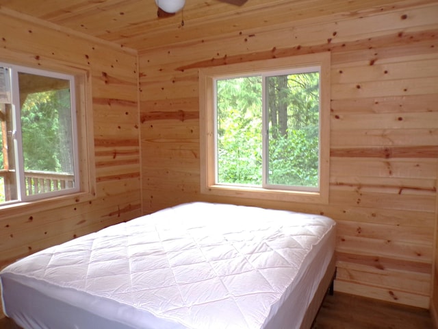 bedroom featuring wood walls