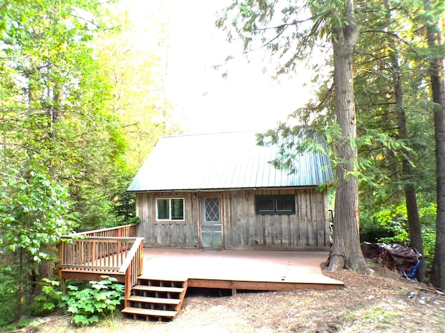 3121 Fifteen Mile Creek Rd, Kettle Falls, WA 99141 - back of property with metal roof and a wooden deck