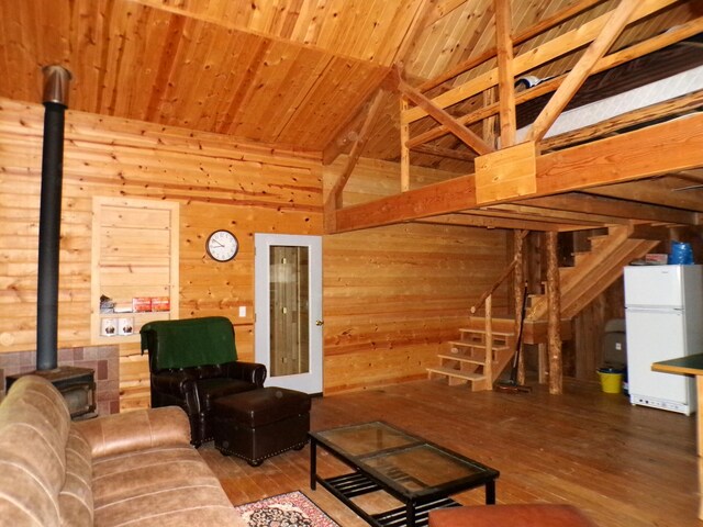 3121 Fifteen Mile Creek Rd, Kettle Falls, WA 99141 - living area featuring wood-type flooring, a wood stove, wooden walls, stairway, and wood ceiling