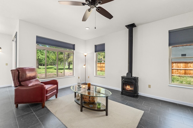 250 Hogans Way, Chewelah, WA 99109 - living room with plenty of natural light, ceiling fan, and a wood stove