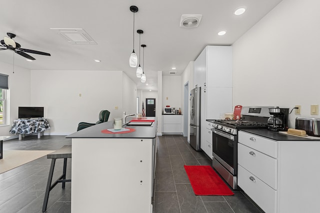 250 Hogans Way, Chewelah, WA 99109 - kitchen featuring stainless steel appliances, a ceiling fan, white cabinets, recessed lighting, and a center island with sink