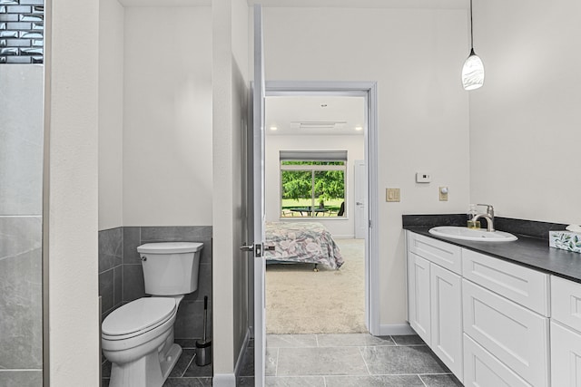 250 Hogans Way, Chewelah, WA 99109 - bathroom with vanity, ensuite bath, tile walls, and a wainscoted wall