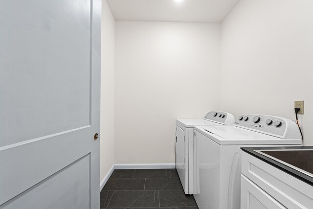 250 Hogans Way, Chewelah, WA 99109 - washroom with washer and clothes dryer, cabinet space, and dark tile patterned floors