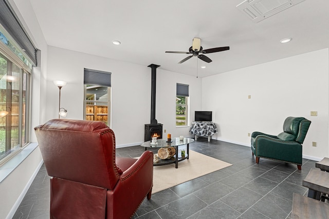 250 Hogans Way, Chewelah, WA 99109 - living area featuring plenty of natural light, a wood stove, a ceiling fan, and recessed lighting