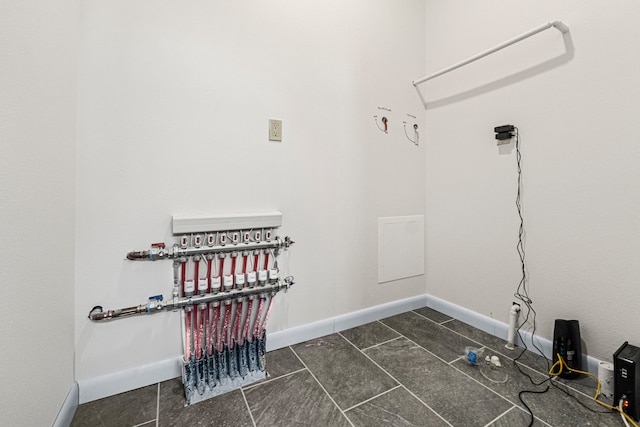 250 Hogans Way, Chewelah, WA 99109 - laundry room featuring dark tile patterned flooring and baseboards