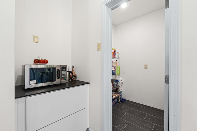 250 Hogans Way, Chewelah, WA 99109 - bar area with stainless steel microwave and dark marble finish floors