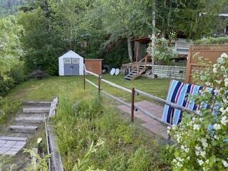 2952 Deep Lake Boundary Rd, Colville, WA 99114 - view of yard featuring a shed, an outbuilding, and a forest view